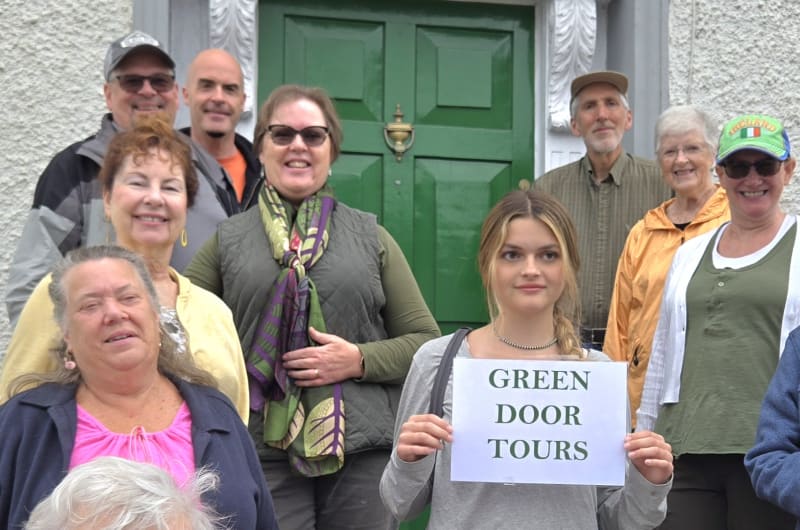 Group Photo With Green Door Tours Sign