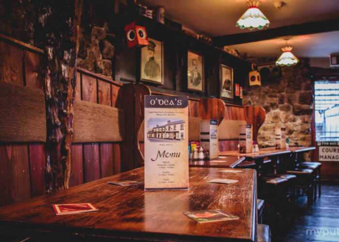 Interior Of Odeas Pub With Wooden Tables 1 ja7nmh