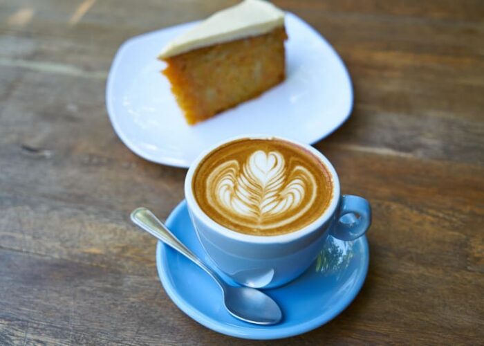 Latte Art Coffee And Carrot Cake On Table kig7kj