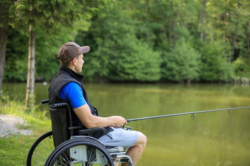 Man In Wheelchair Fishing By A Lake dyklgv