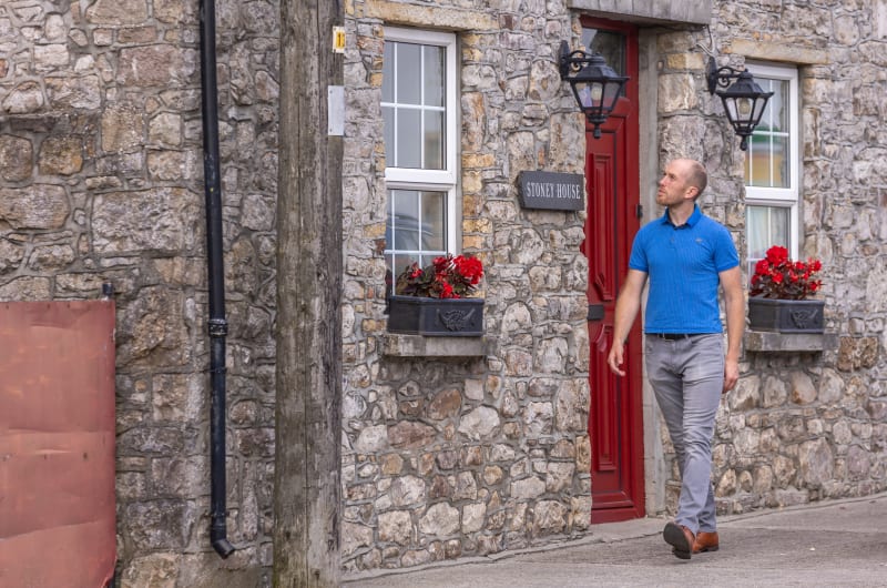 Man Walking Past Stoney House Stone Building nri9a2