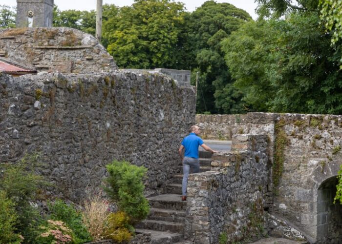 Man Walking Up Stone Steps By Stone Walls qfjyfn