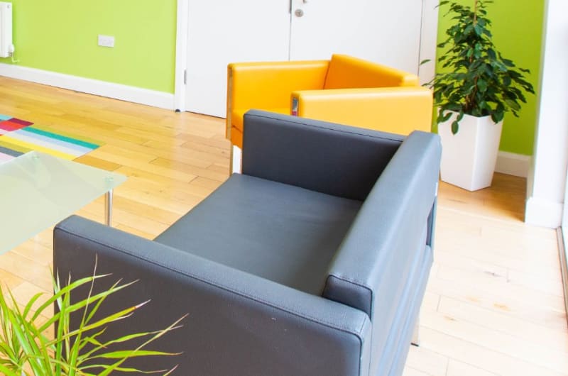 Modern reception area with green wall and furniture