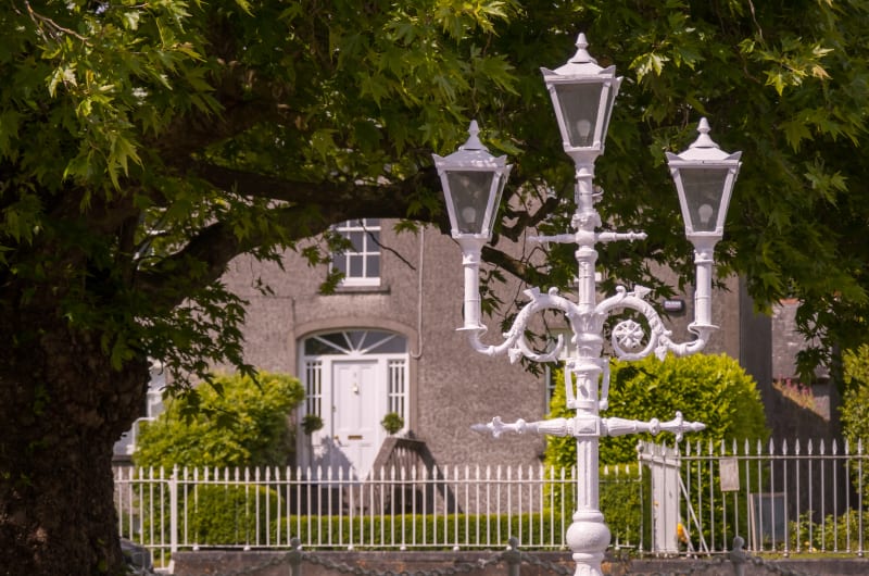 Ornate White Street Lamp In Front Of Building pq8ywz