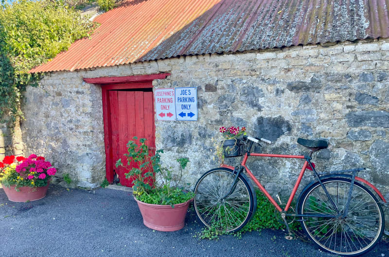 Red Bicycle Against Stone Wall With Parking Signs kujy95