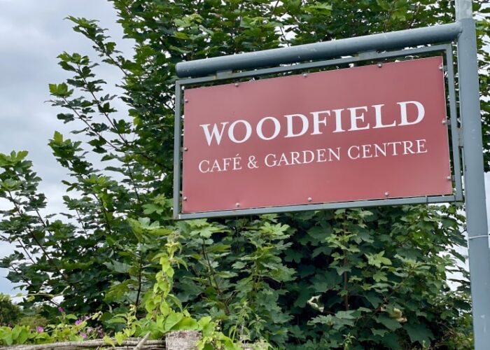 Red sign for Woodfield Cafe and Garden Centre tuxvyi