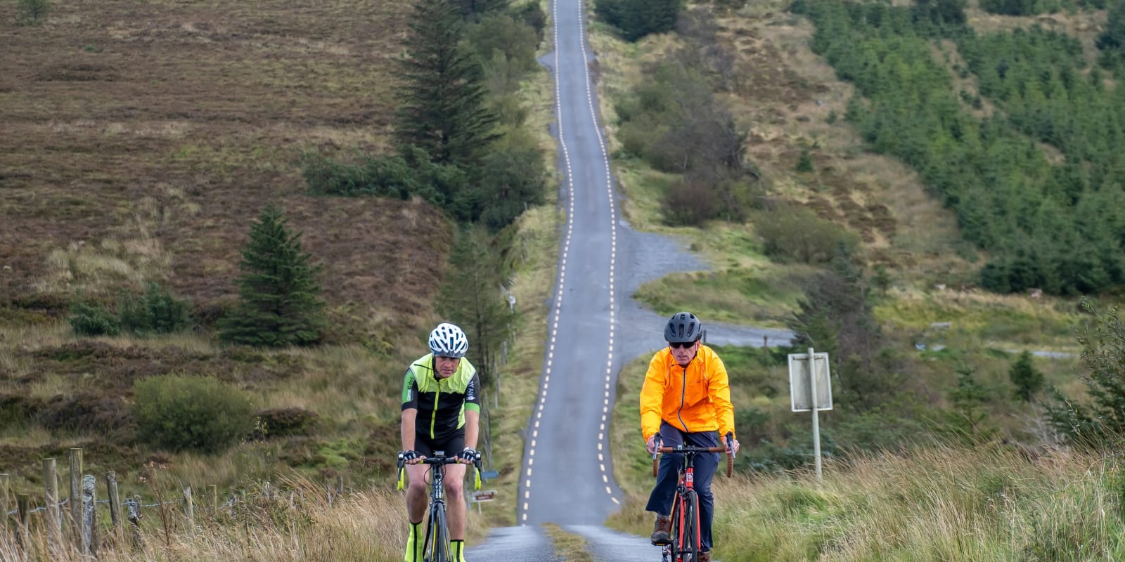 Road Cycling Header Image Two Cyclists Riding On A Long Hilly Road ge3hlf