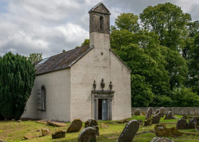 Small Stone Church With Old Cemetery Headstones pqzz8o