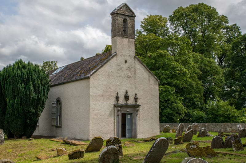 Small Stone Church With Old Cemetery Headstones pqzz8o