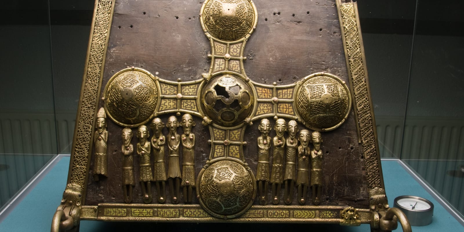 St Manchans Shrine Header Image Gilded Cross And Figures On Wooden Shrine