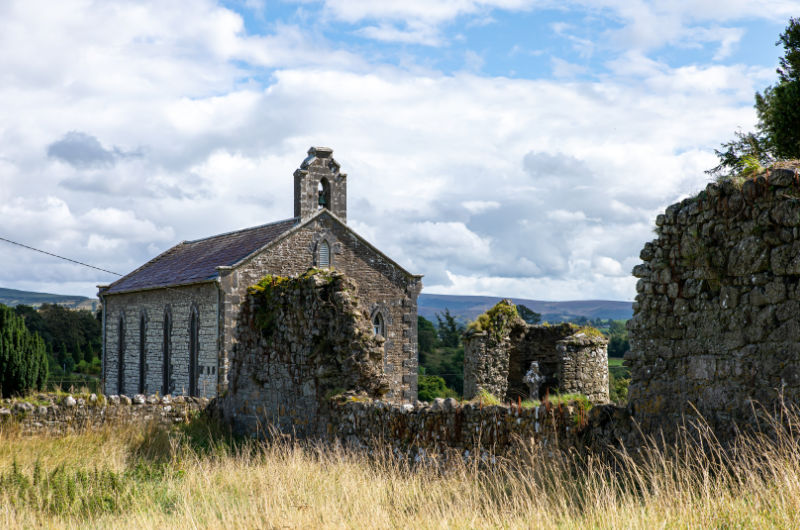Stone Church And Ancient Ruins In Rural Landscape