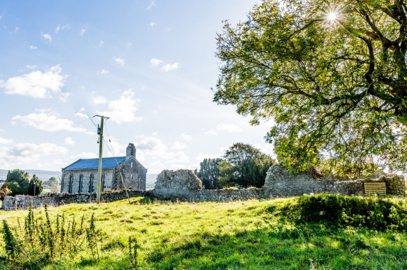 Stone Church Ruins In Sunny Grassy Field