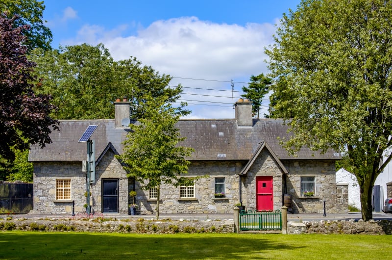 Stone cottage with red and black doors f7swnv
