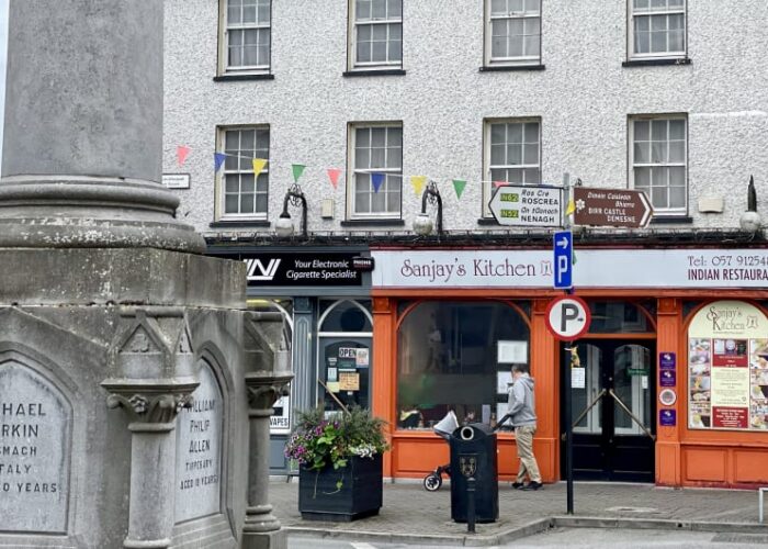 Street view showing Sanjays Kitchen and memorial monument yswz5q