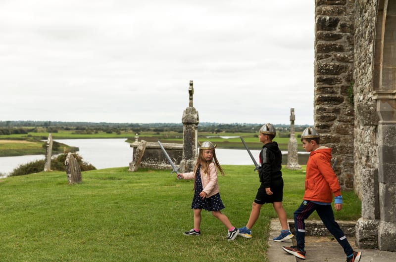 Three Children Dressed As Vikings At Clonmacnoise Ruins