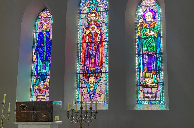 Three Religious Stained Glass Windows Above An Altar p1klub