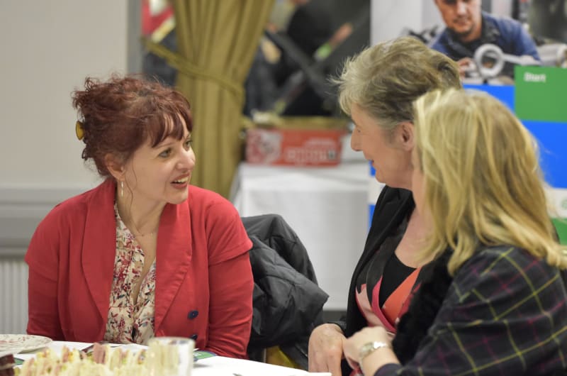 Three Women Talking At A Table