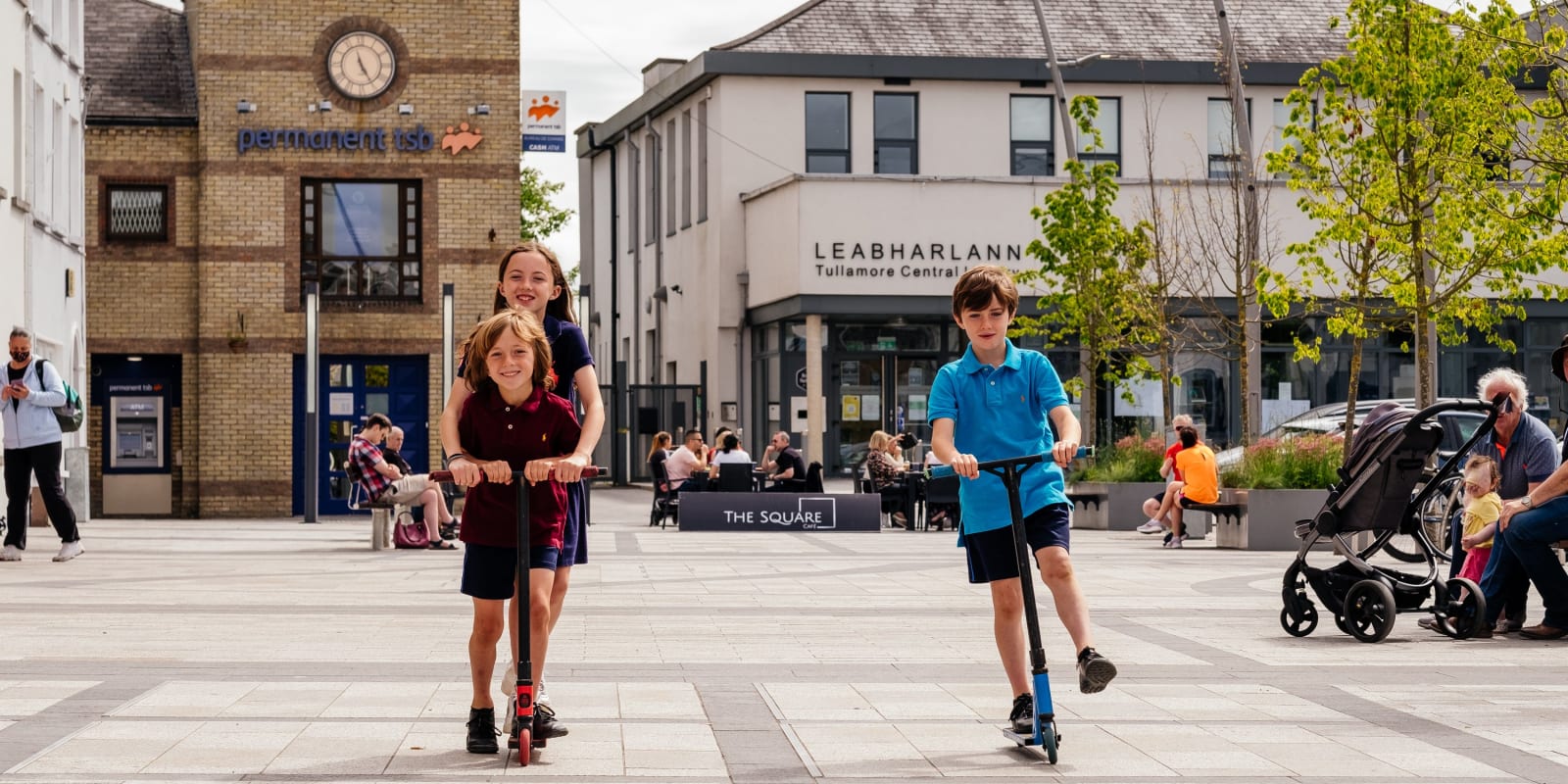 Tullamore Header Image Children playing on scooters in Tullamore square