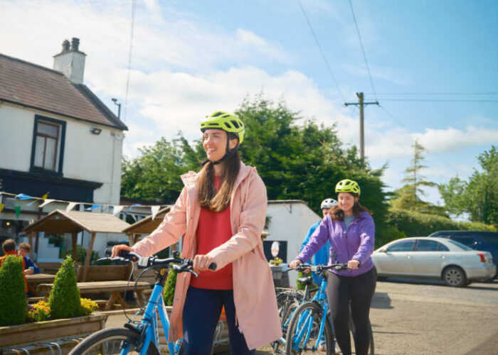 Two Women Riding Bicycles Near House In Offaly n8rvrf