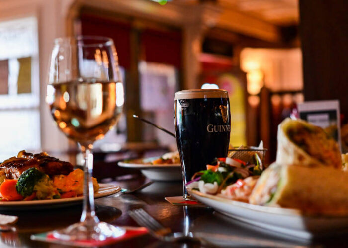 glass of wine and pint of guinness with bar meal