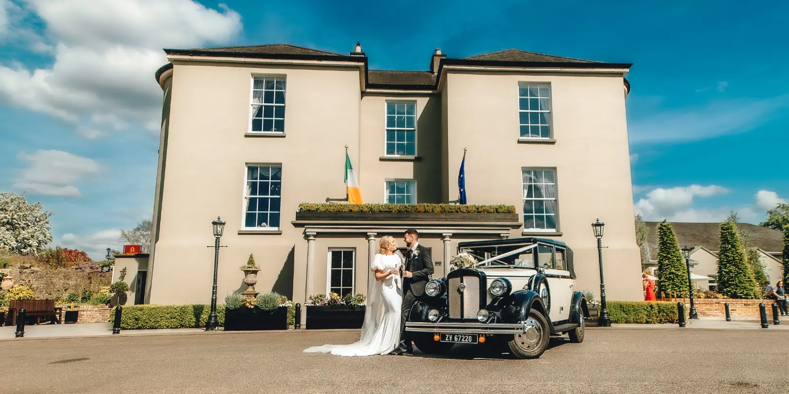 header county arms just married couple outside hotel with car