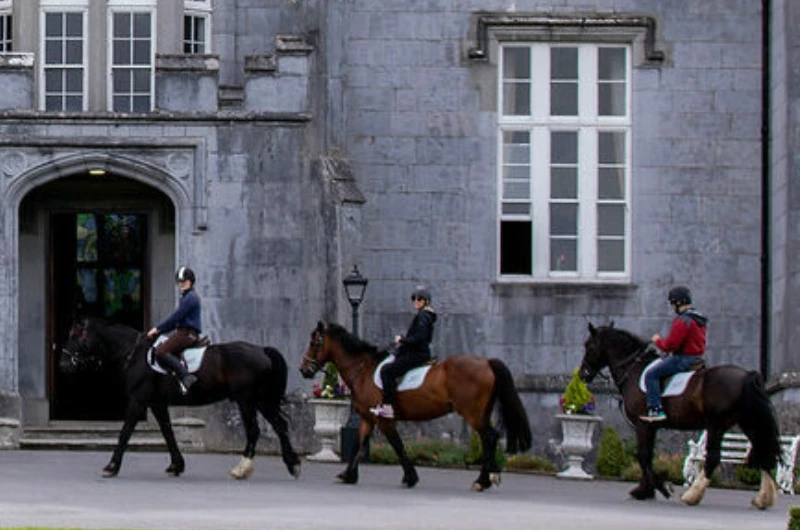 horse riders outside castle