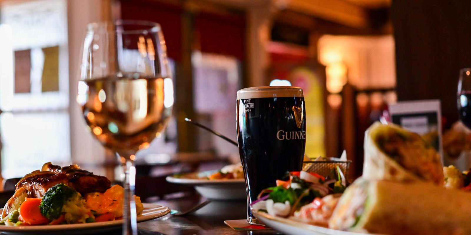 pint of guinness with wine and meals header
