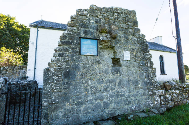 rahan wall ruin with signs near white church