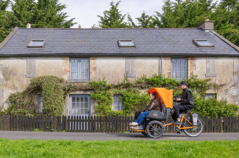 rickshaw passing cottage
