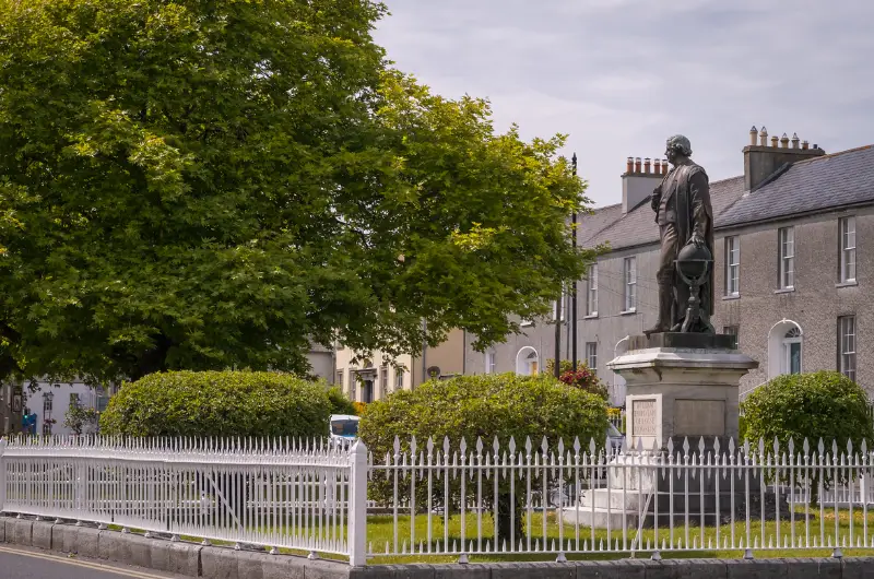 statue behind fence