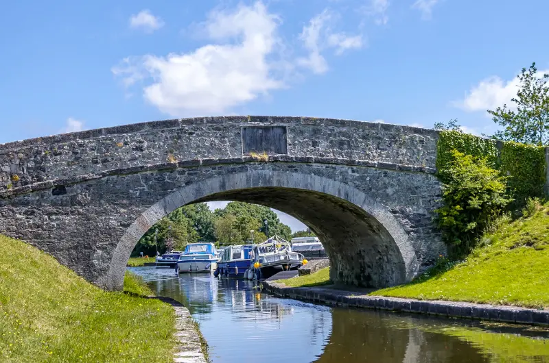 stone bridge over canal with grassy banks