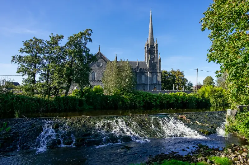 view of church by small waterfall