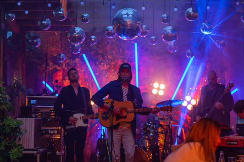 Band performing live with disco balls and lights o6vybm