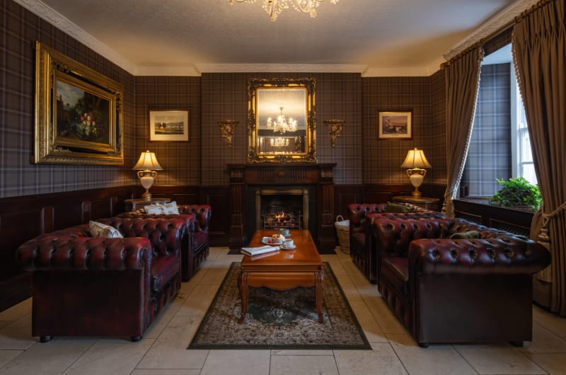 Elegant hotel lounge with leather sofas and fireplace