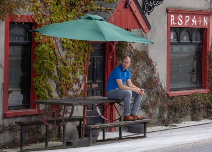 Man Sitting At Picnic Table Outside R Spain