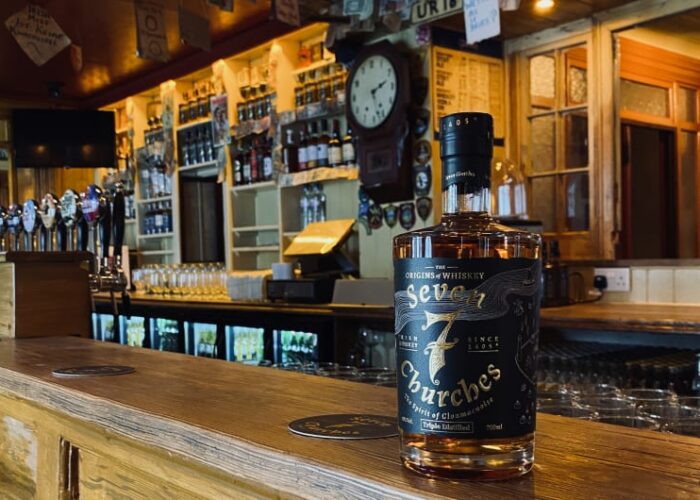 Seven Churches Irish Whiskey Bottle On Wooden Bar un1hoj