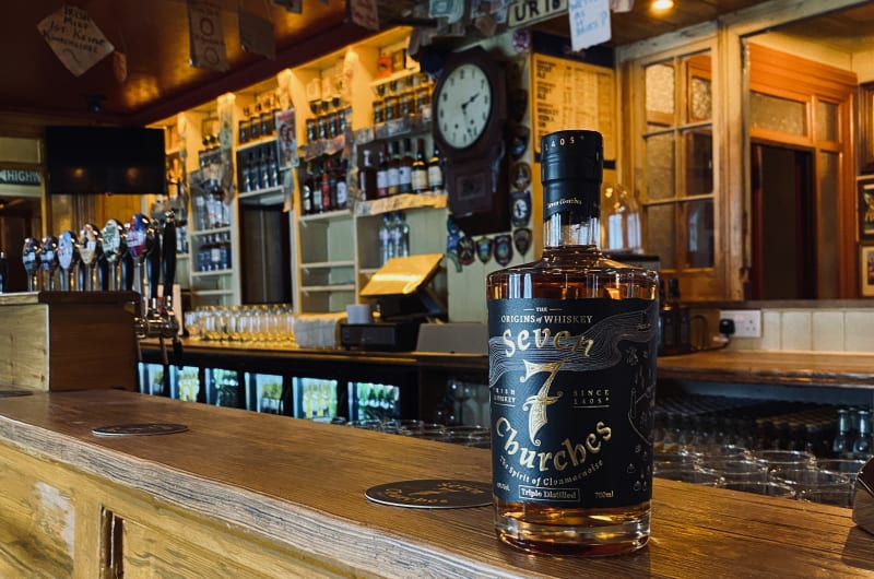 Seven Churches Irish Whiskey Bottle On Wooden Bar un1hoj