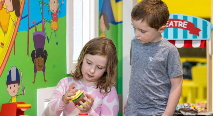 Two Children Playing With A Toy Tea Set aymfkg