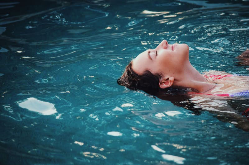 Woman Floating On Her Back In Water