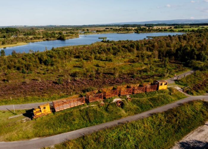 Yellow peat train at Lough Boora Parklands landscape zqwdw9