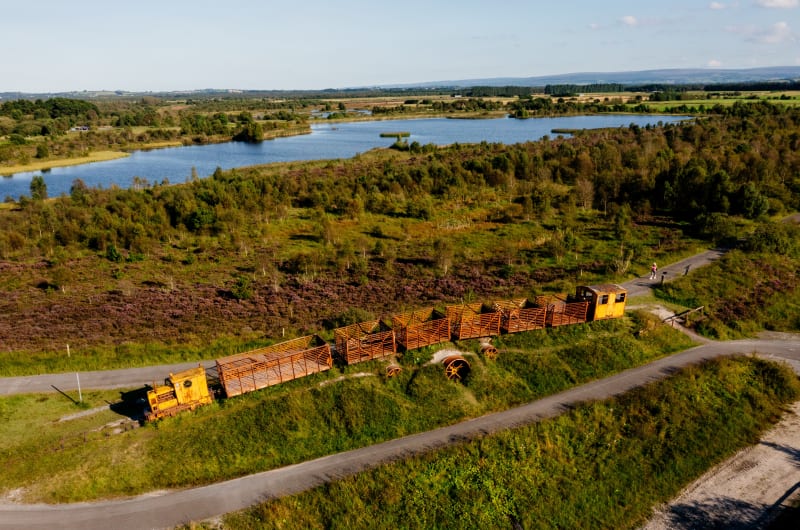 Yellow peat train at Lough Boora Parklands landscape zqwdw9