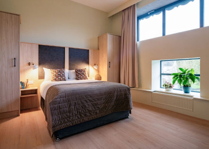bedroom with large windows plant