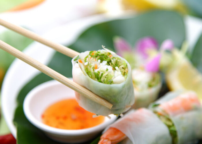 chopsticks holding sushi