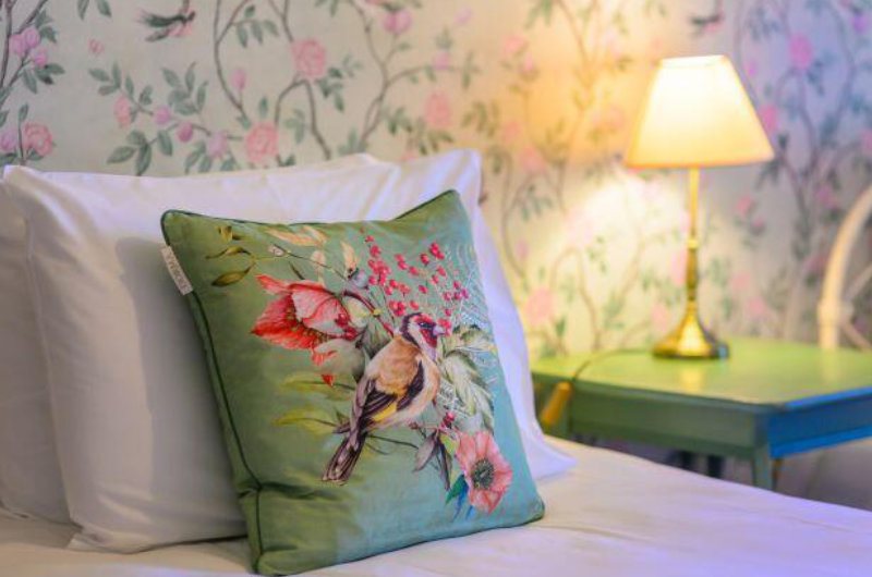 flowery cushin on pillow bed