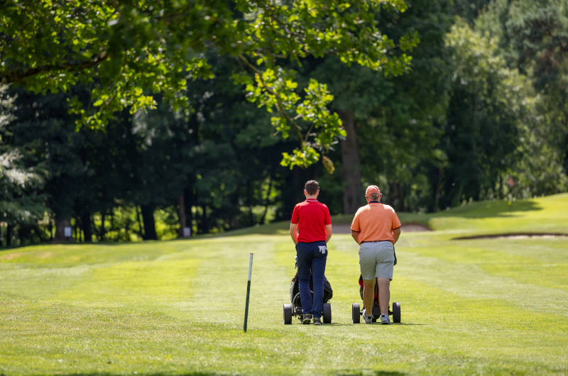 golfers walking away with cadies