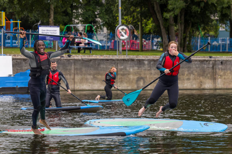 group of people having fun with canoes on river