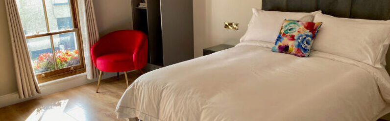 jj killeen double bedroom with red chair