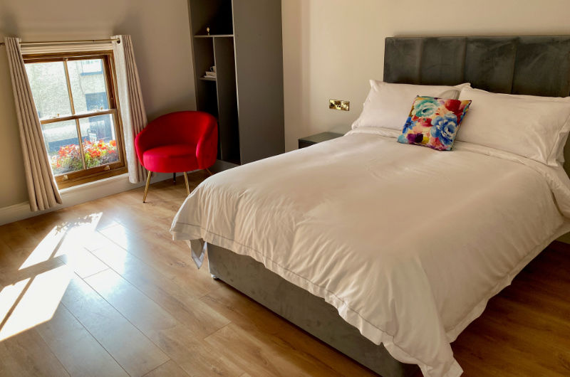 jj killeen double bedroom with red chair