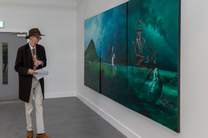 older man looking at large painting in art gallery
