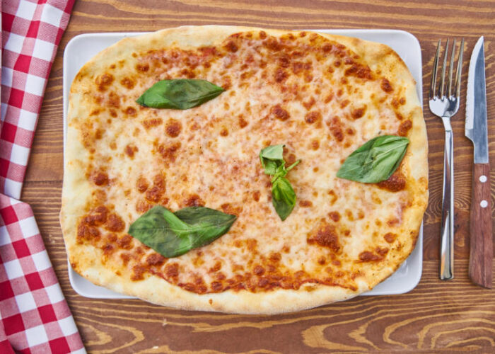pizza on plate with red and white checkered cloth